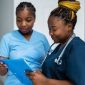 Two nurses looking at charts.